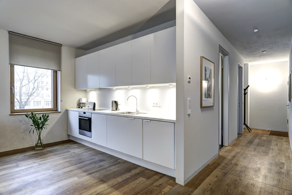 Furnished apartment, kitchen with white gloss cabinets in Berlin Friedrichshain