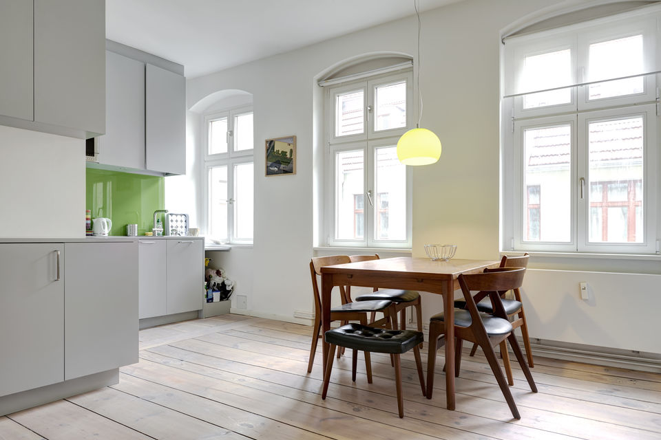 Furnished apartment, dining room with wooden table and designer pendant light in Berlin Mitte