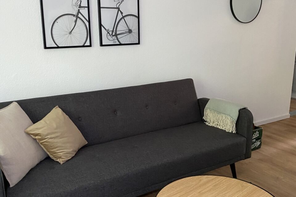 Furnished apartment, living room with dark gray sofa in Berlin Treptow-Köpenick
