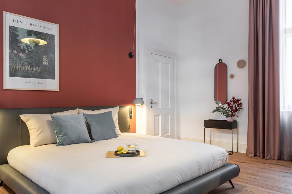 Furnished apartment, bedroom with red accent wall in Berlin Charlottenburg