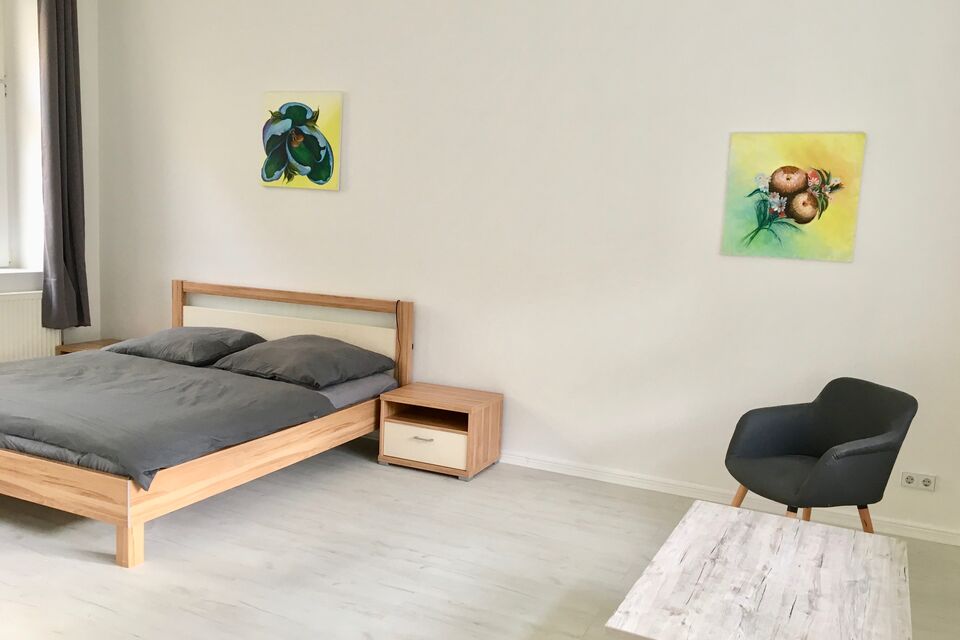 Furnished apartment, bedroom with wooden bed in Berlin Friedrichshain