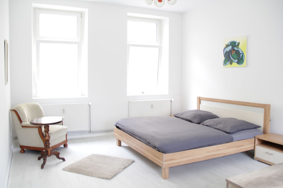Furnished apartment, bedroom with wooden bed in Berlin Friedrichshain