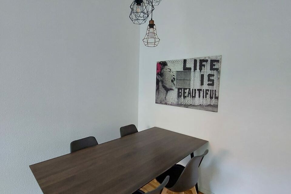 Furnished apartment, dining room with wooden table in Berlin Neukölln