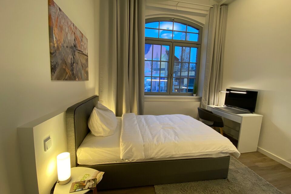 Serviced apartment, bedroom with city view in Berlin Mitte
