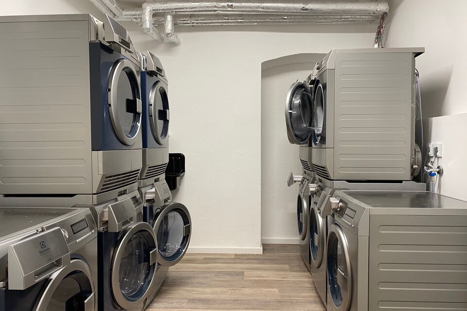 Serviced apartment, laundry room with stacked dryers in Berlin Mitte