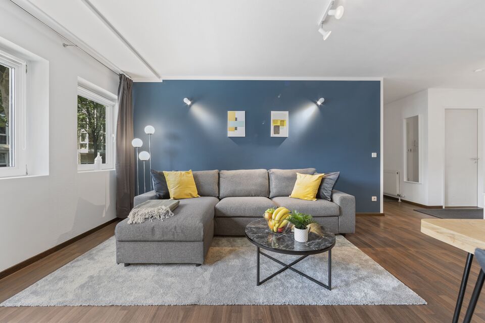 Furnished apartment, living room with blue accent wall in Berlin Tegel