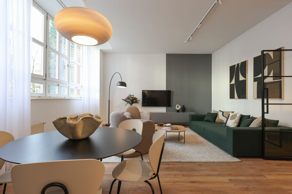 Furnished apartment, living room with green sofa in Berlin Friedrichshain