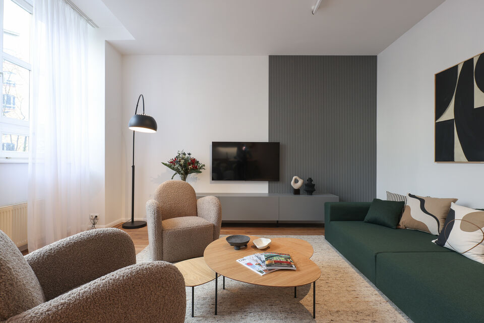 Furnished apartment, living room with green sofa in Berlin Friedrichshain