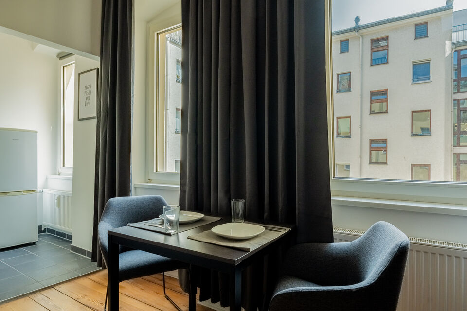 Furnished apartment, living room with floor-to-ceiling curtains in Berlin Kreuzberg