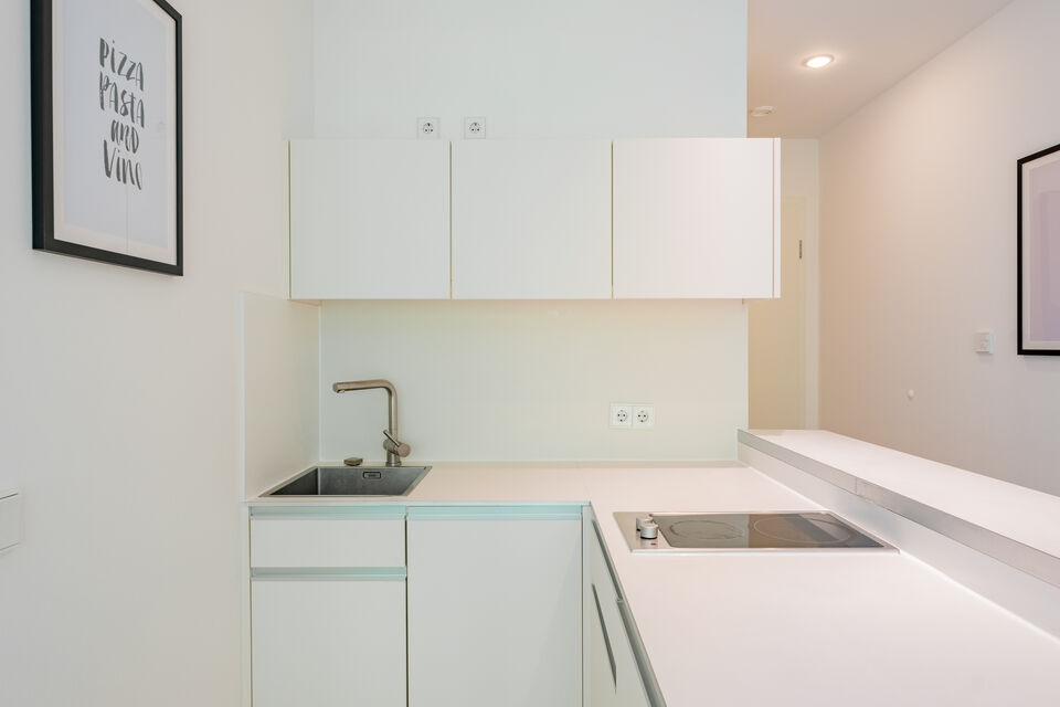 Furnished apartment, kitchen with white fitted cabinets in Berlin Kreuzberg