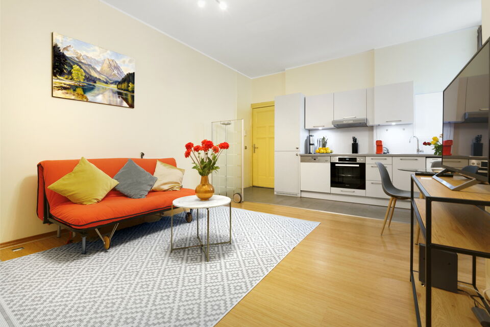 Furnished apartment, living room with orange sofa in Berlin Wilmersdorf