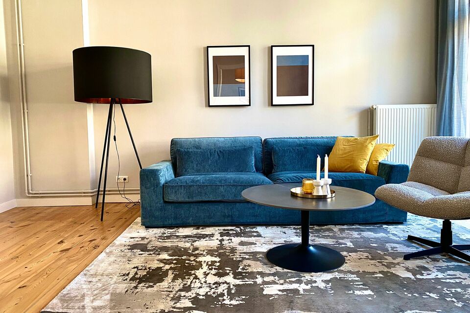 Furnished apartment, living room with blue sofa in Berlin Charlottenburg