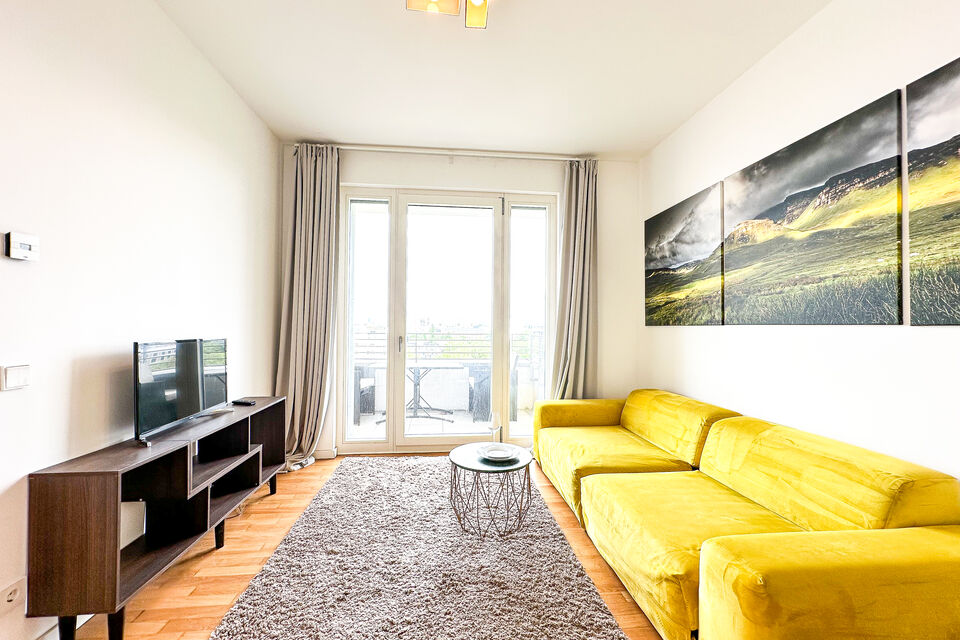 Furnished apartment, living room with yellow sofa in Berlin Tiergarten