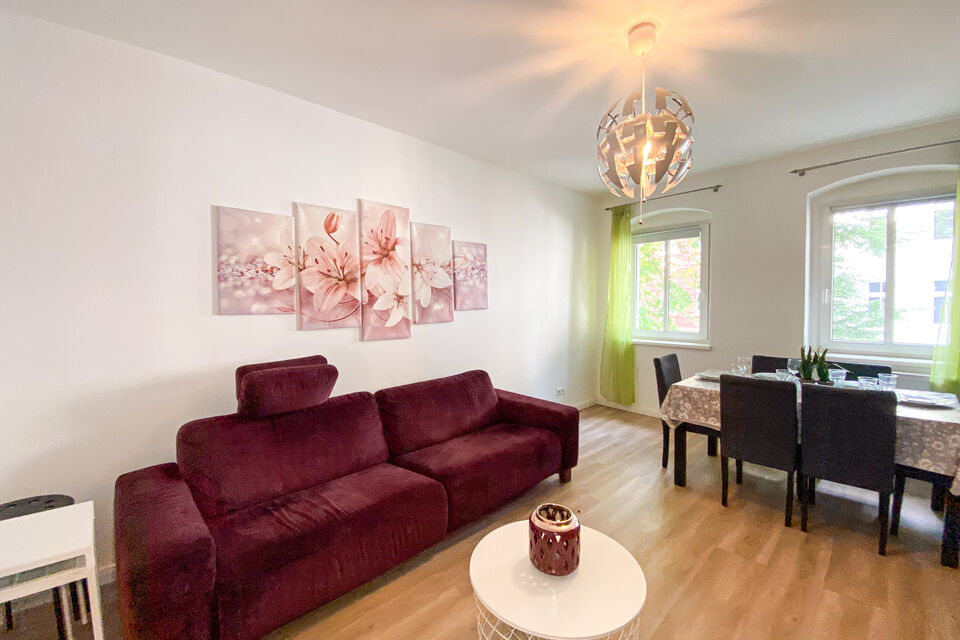 Furnished apartment, living room with burgundy velvet sofa in Berlin Weißensee