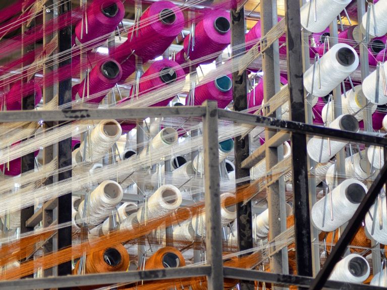 White pink orange reel spool sewing threads textile weaving mill copy