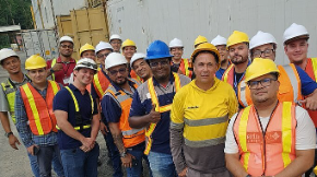 A group of construction workers wearing helmetsAlt text