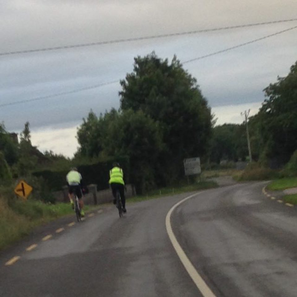 John and Ross cycling away from the camera