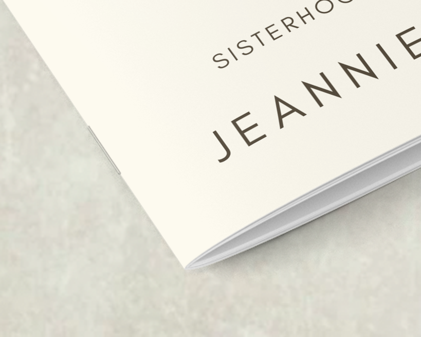 Close-up of a catalogue corner showing saddle-stitch binding with two staples along the centerfold.