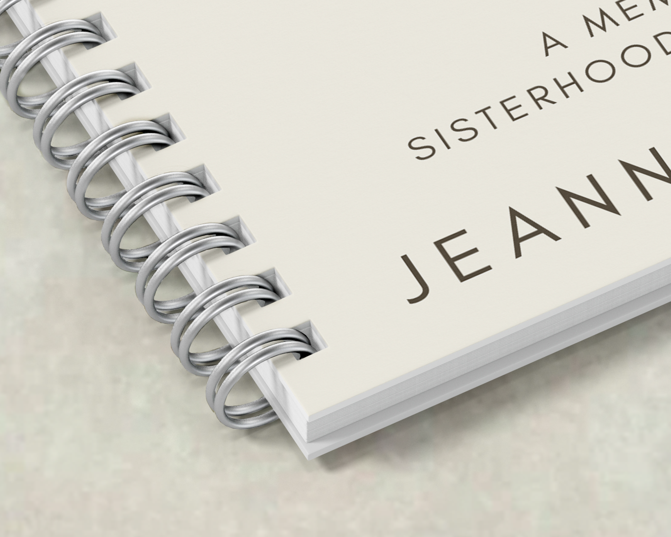 Close-up of a booklet corner showing wire binding with C-shaped wire loops.