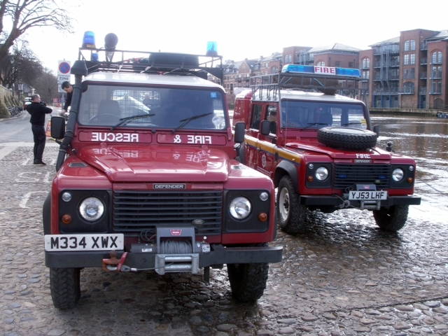 Landrovers down by the river.