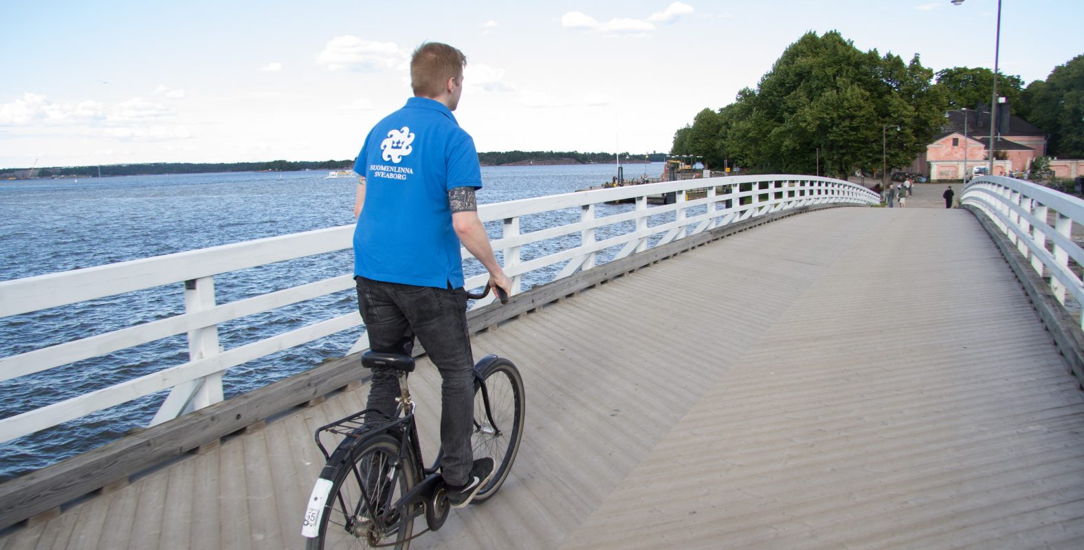 Kesävalvoja pyöräilee sillalla