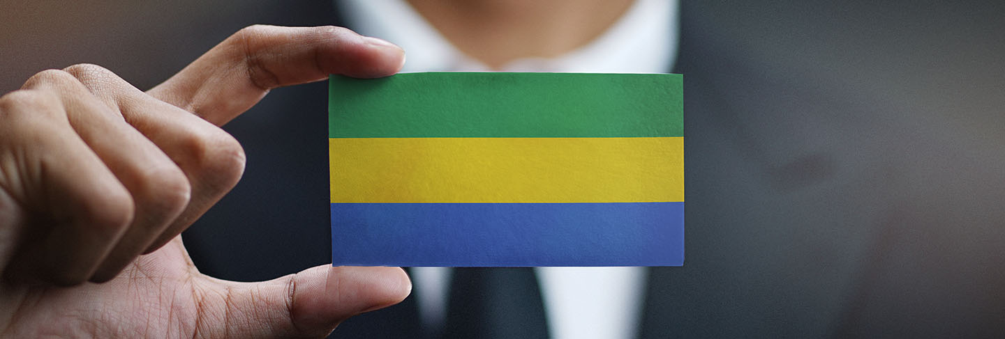 Businessman holding card of gabon flag
