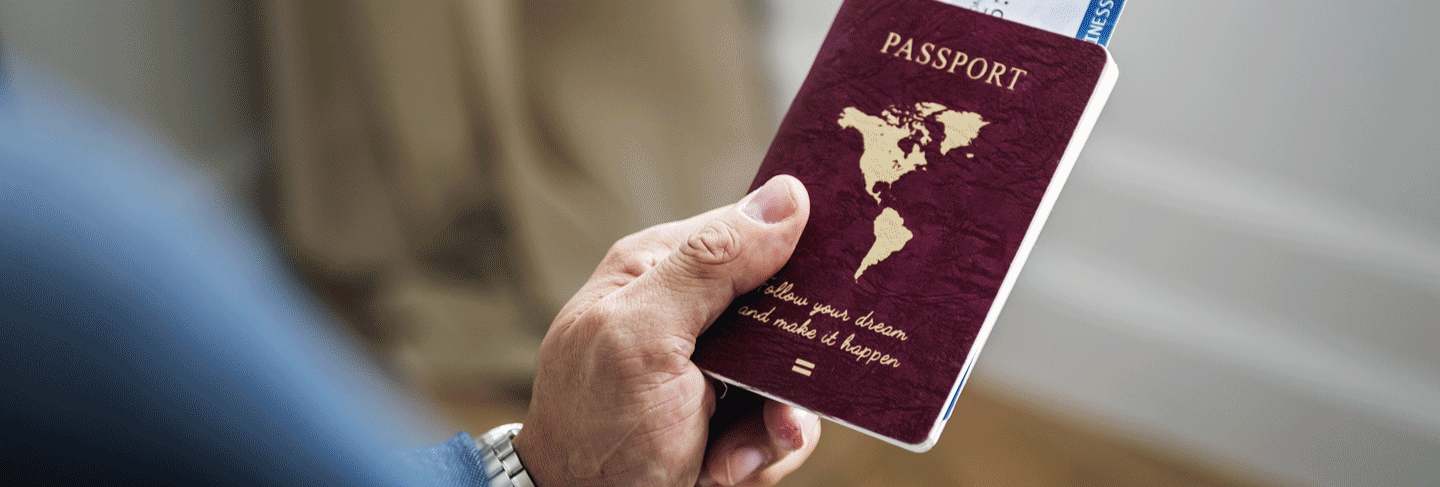A person holding a passport contemplating what is a visa