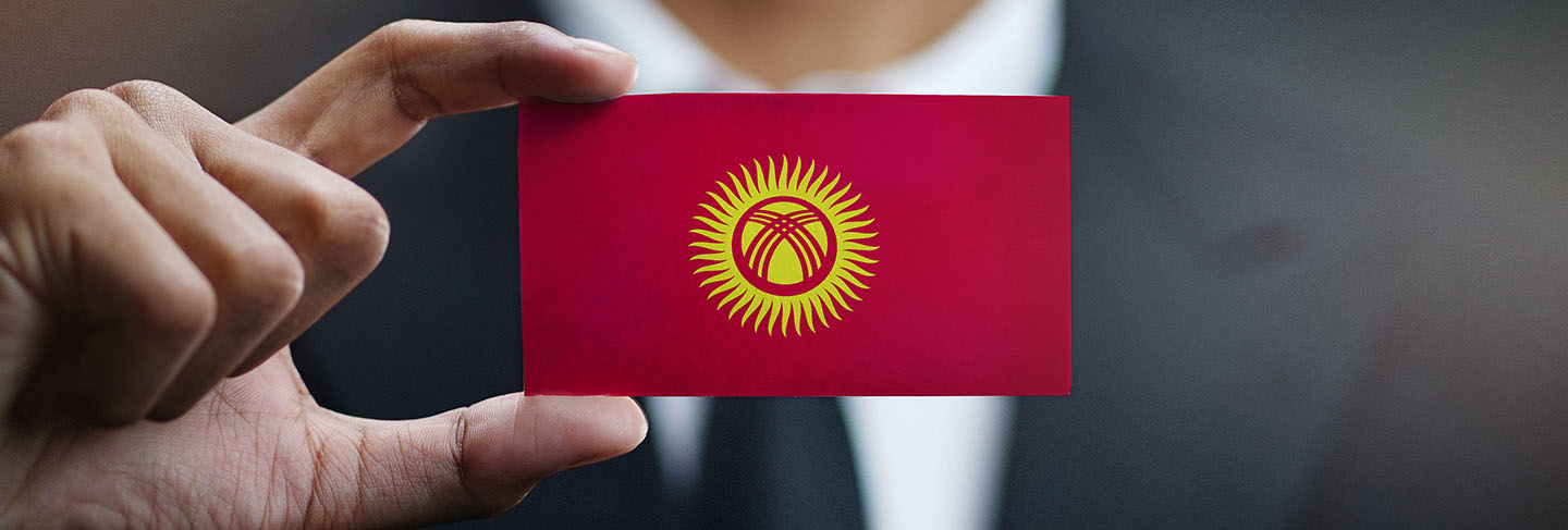 Businessman holding card of kyrgyzstan flag