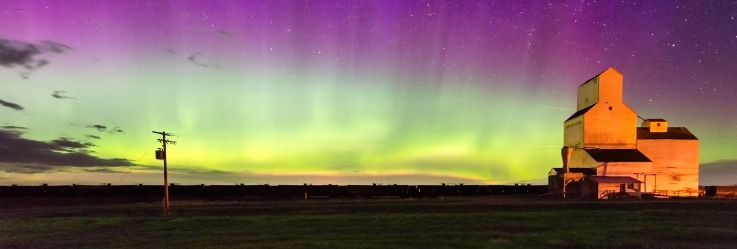 Aurora borealis northern lights over a historic grain elevator