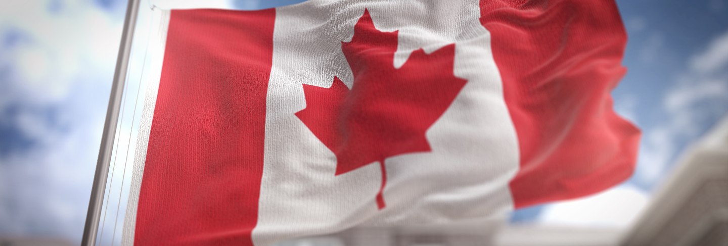 Canada flag 3d rendering on blue sky building background