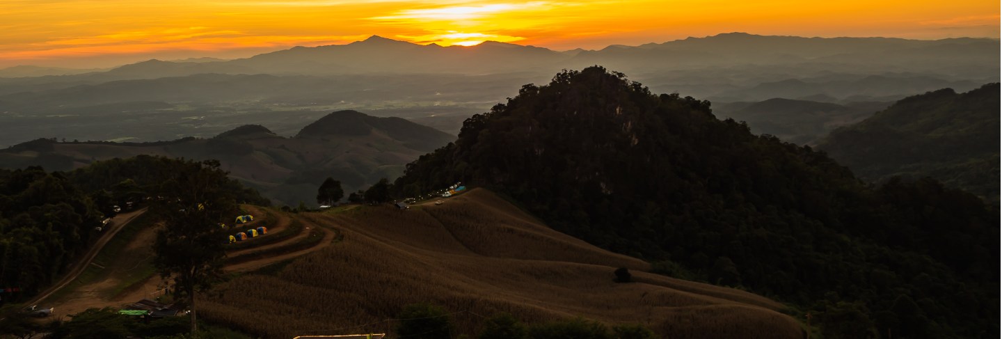 Tent in the sunset overlooking mountains