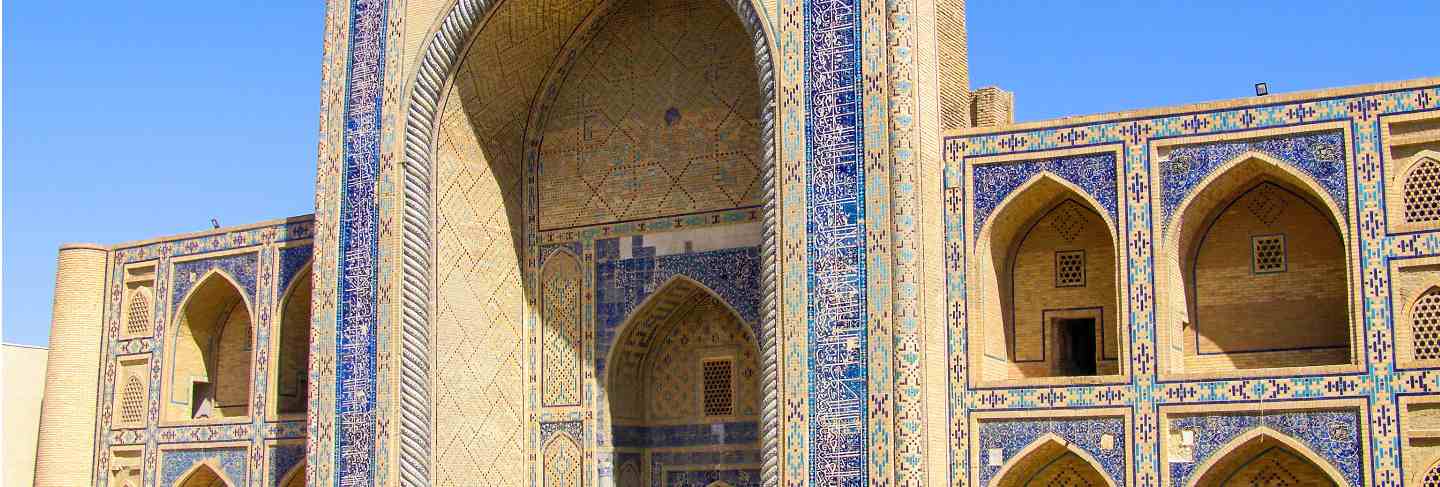 Side view of ulugbek medressa, the oldest madrasa of central asia, in bukhara, uzbekistan.