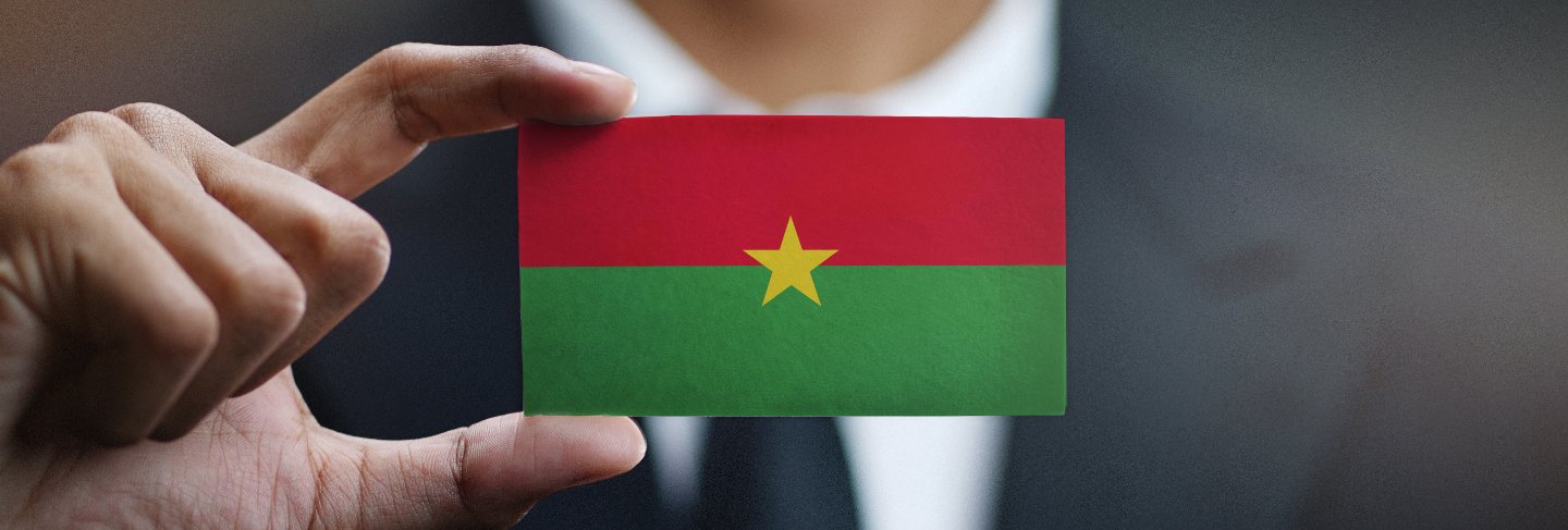 Businessman holding card of burkina faso flag