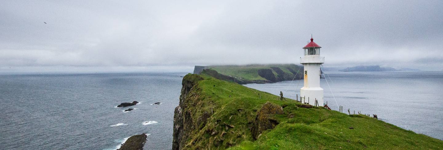 Mykines lighthouse, faroe islands. foggy view of old lighthouse