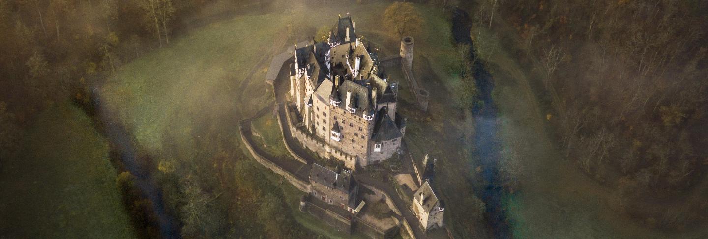 Aerial shot of the eltz castle surrounded by trees in wierschem, germany