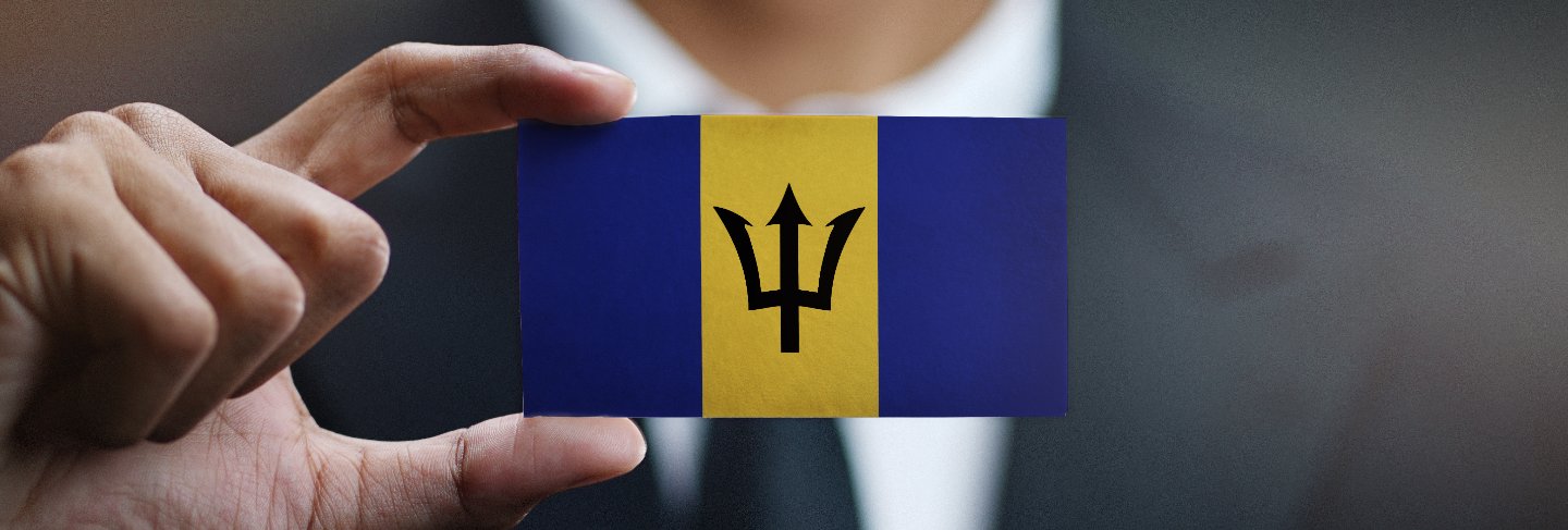 Businessman holding card of barbados flag