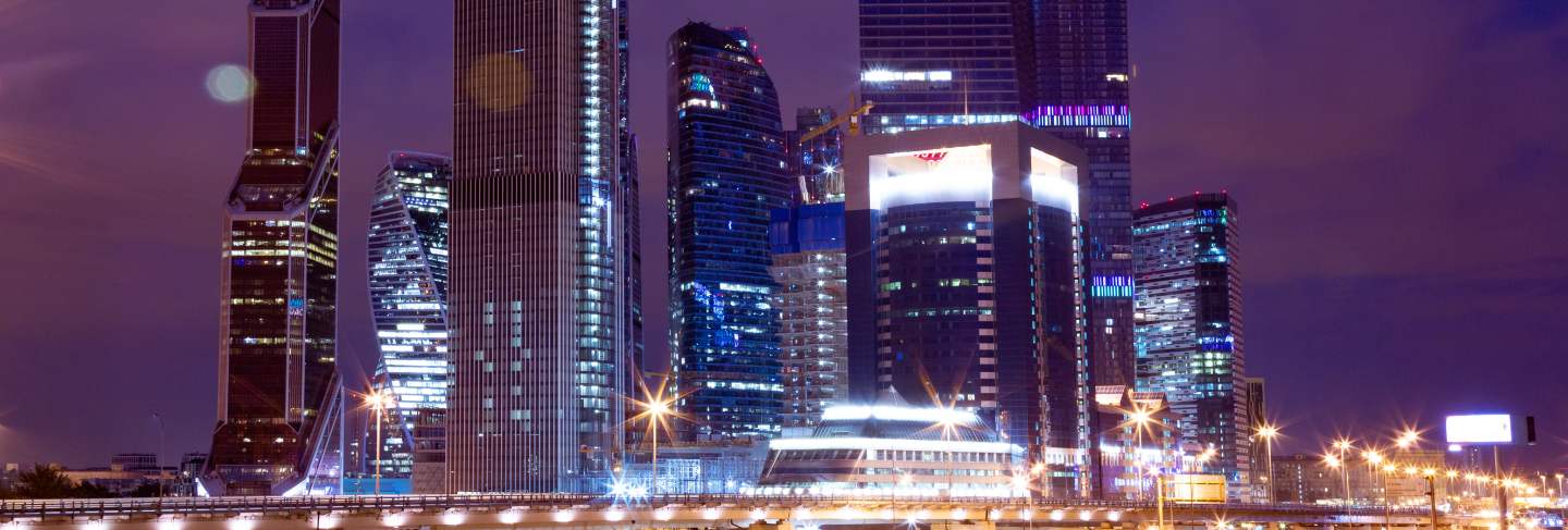 Business architecture - skyscrapers and light trails. modern business center in the night lights