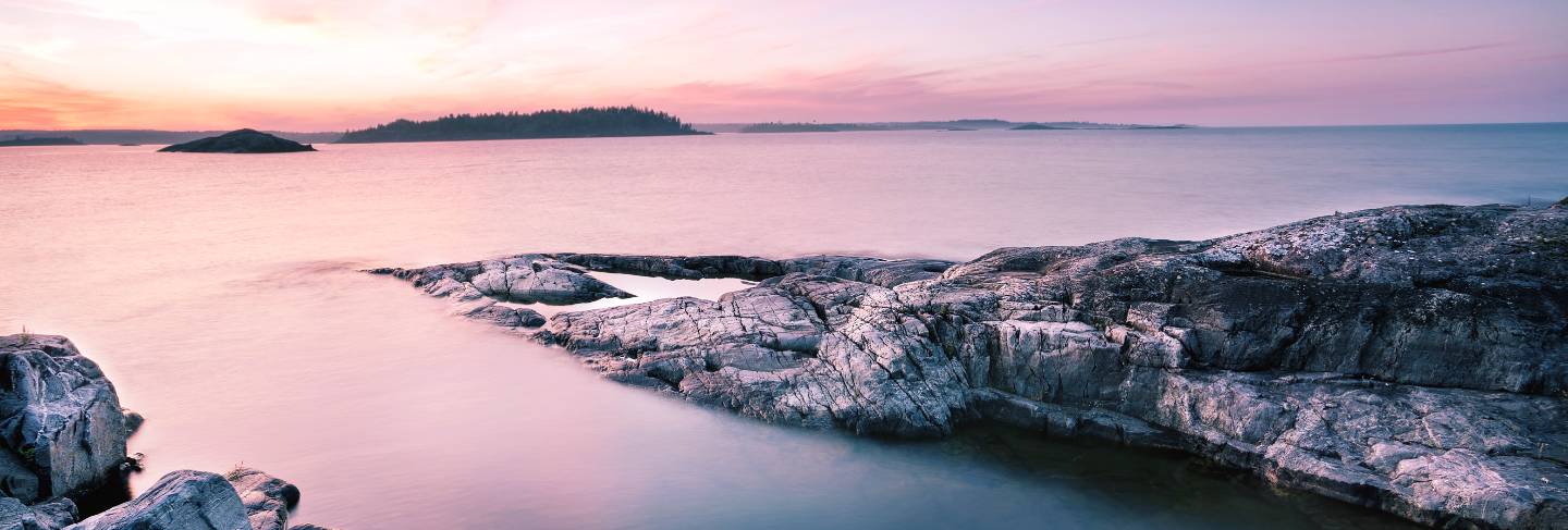Textured stone island under dawn sky