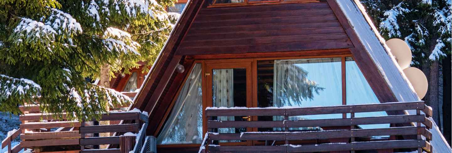 Wooden house in winter forest