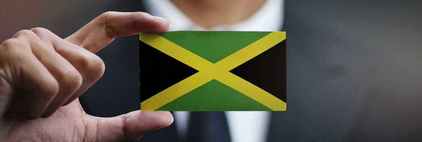 Businessman holding card of jamaica flag