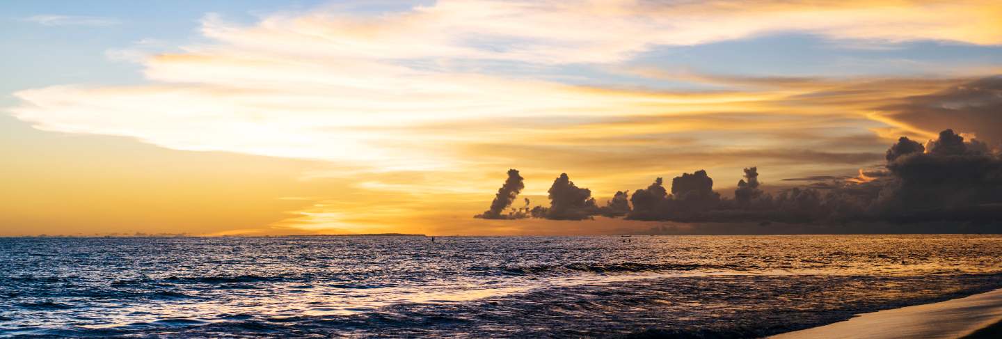 Sunset on the ocean. beautiful bright sky, reflection in water, waves
