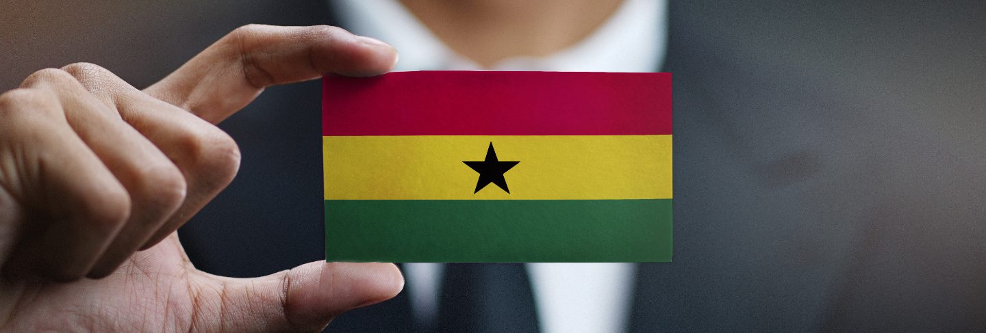 Businessman holding card of ghana flag