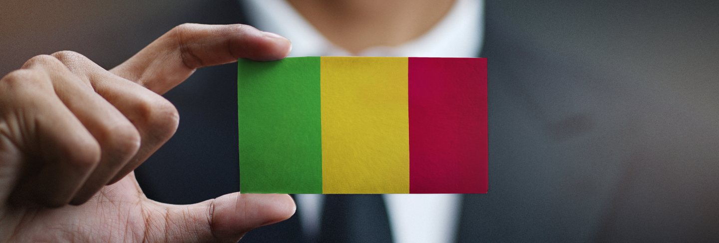 Businessman holding card of mali flag