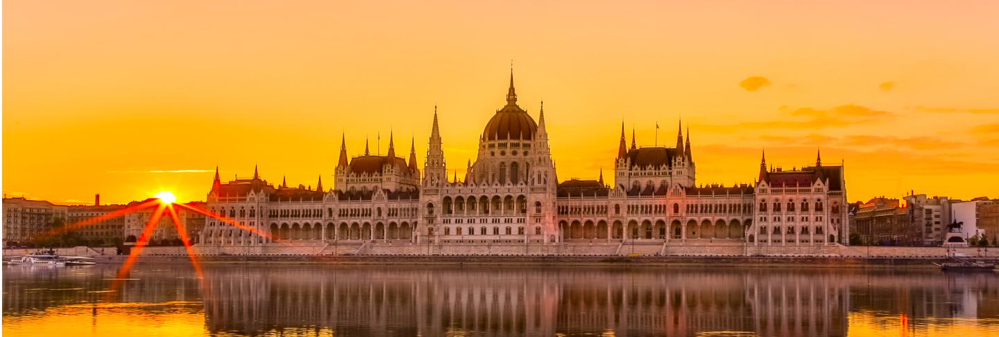 Sunset view of budapest parliament building with danube river in hungary