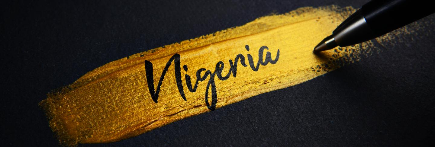 Nigeria handwriting text on golden paint brush stroke
