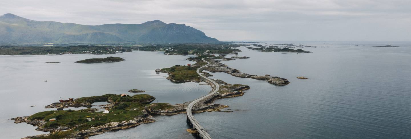 Distant shot of a long overpass road on the body of the water surrounded with small islands