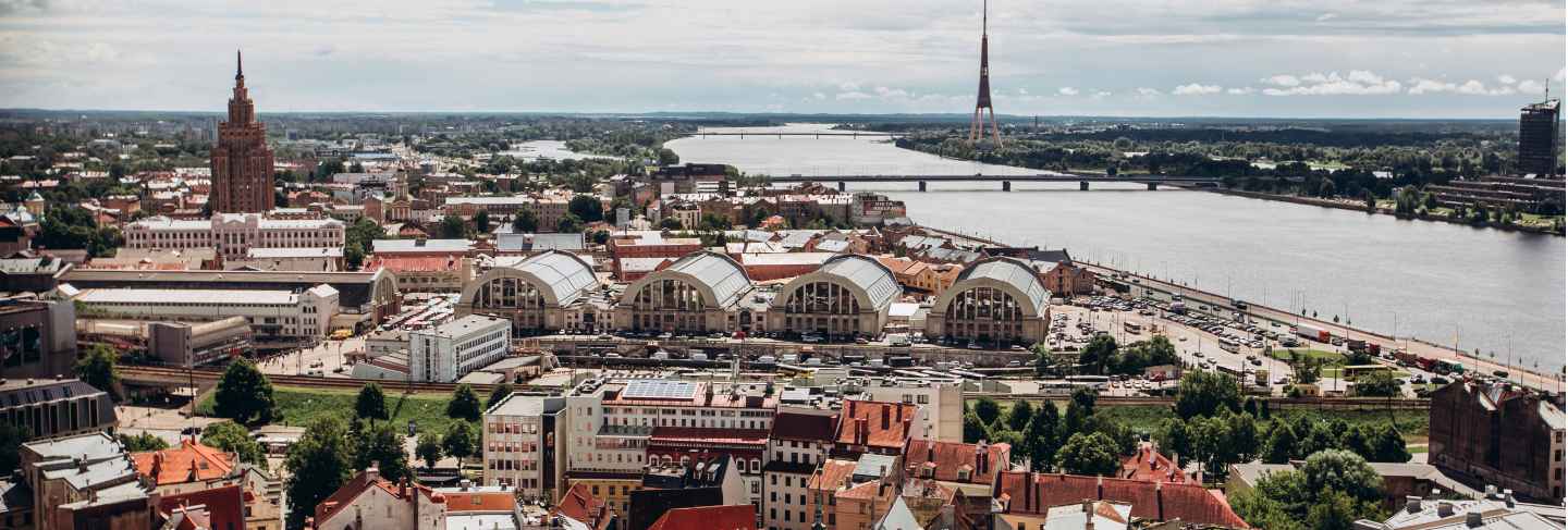 Red roofs of old riga. riga cityscape on a sunny summer day. city aerial view of the old town with the dome cathedral and the daugava river in the city of riga