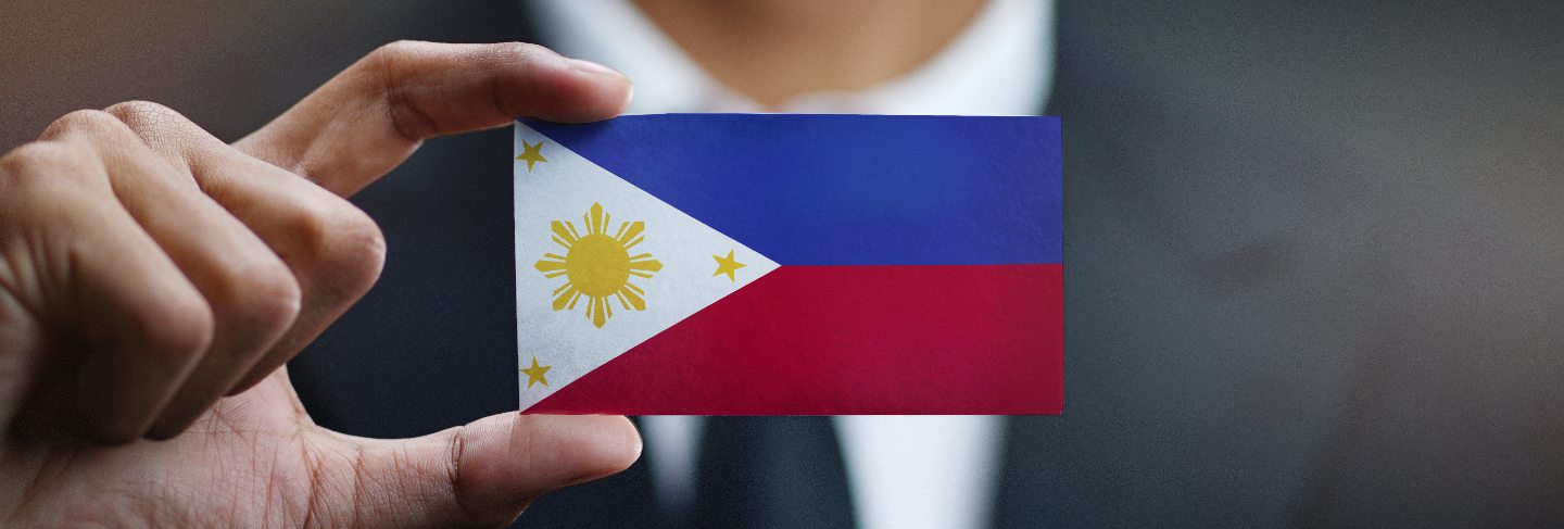 Businessman holding card philippines flag