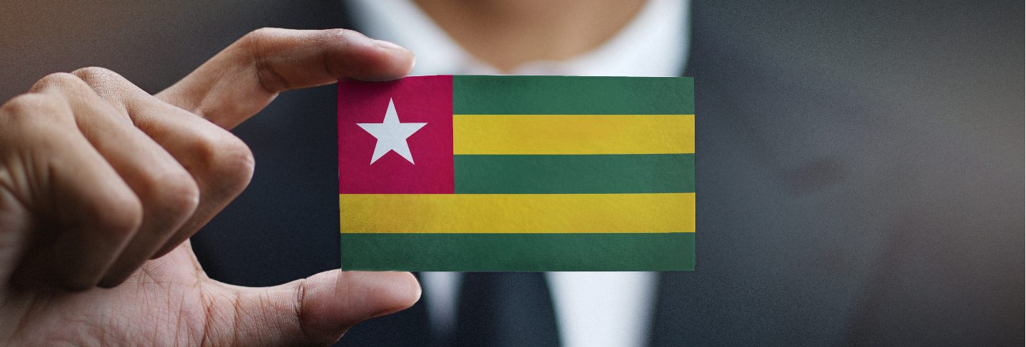 Businessman holding card of togo flag