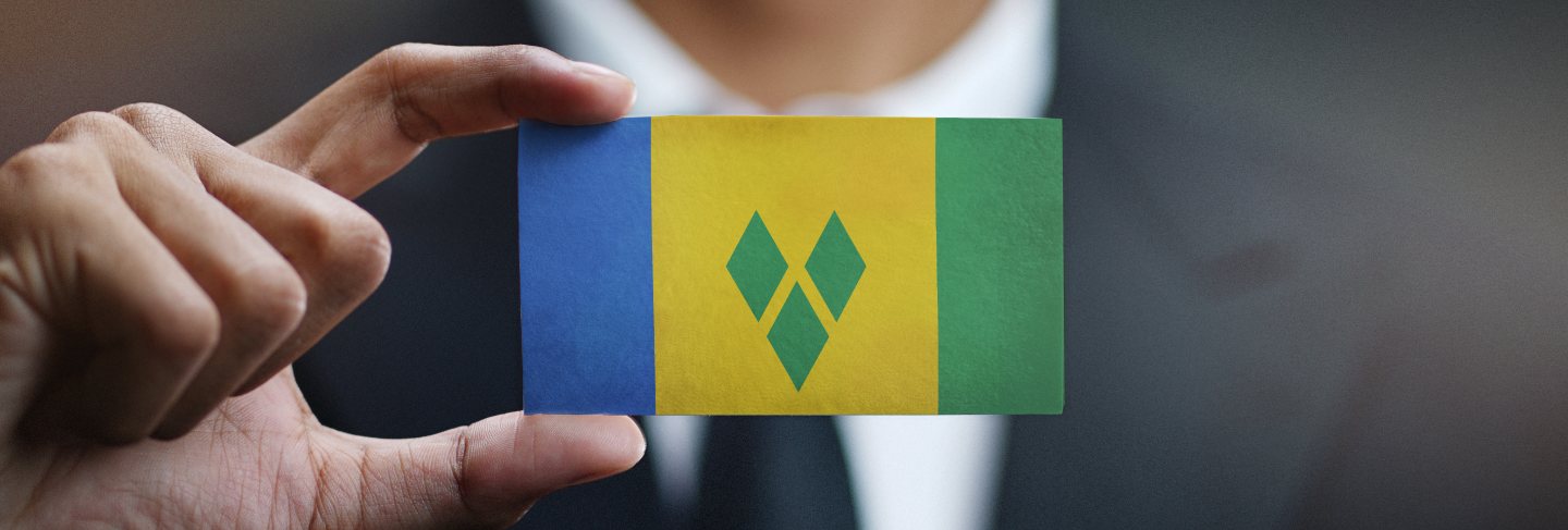 Businessman holding card of saint vincent and the grenadines flag